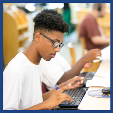 teen sitting at computer