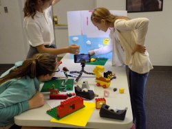 3 teen girls setting up a stop motion scene