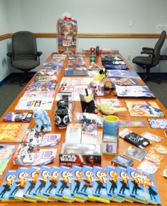 conference table covered in comic books and other prizes