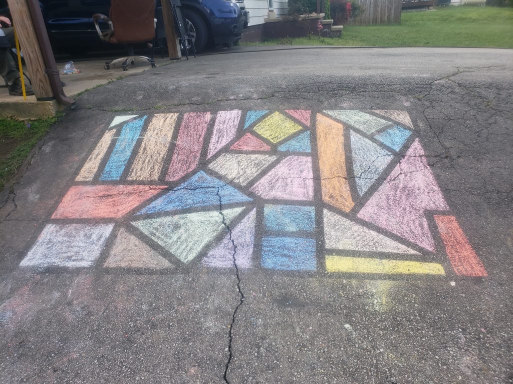 chalk drawing of multi-colored shapes on a driveway