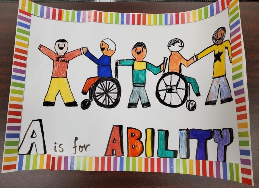 3 standing figures and 2 figures in wheelchairs holding hands, with the words A is for Ability