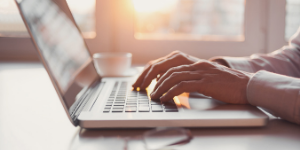 hands typing on a laptop