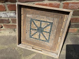 blue and cream stone mosaic in a wooden frame