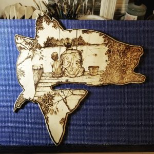Wooden rockfish with a fishing scene burned into it
