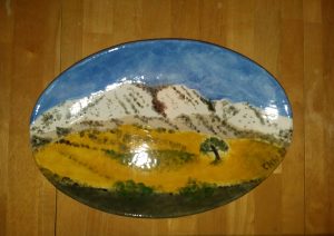 painted plate with image of a mountain
