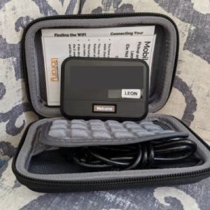 Black hotspot with a tag reading Leon inside an open small black case with paperwork