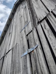 Close up of the side of a grey barn