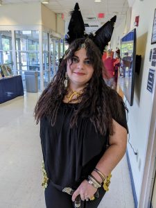 Woman dressed in all black with tall black ears on top of her head