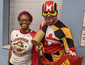 Man dressed in a Maryland costume with helmet, woman in a white shirt