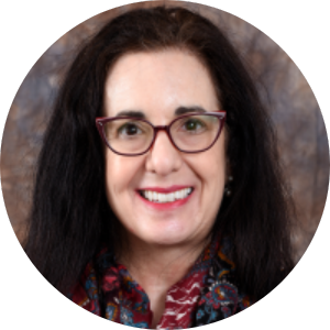 Headshot of a white woman with long dark hair wearing glasses