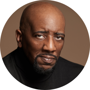 Headshot of a Black man wearing a black shirt