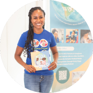 A Black woman with long braids in a blue t-shirt reading Preemie Power, holding a children's picture book