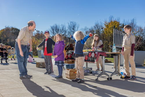 Children participate in an apple cider making event