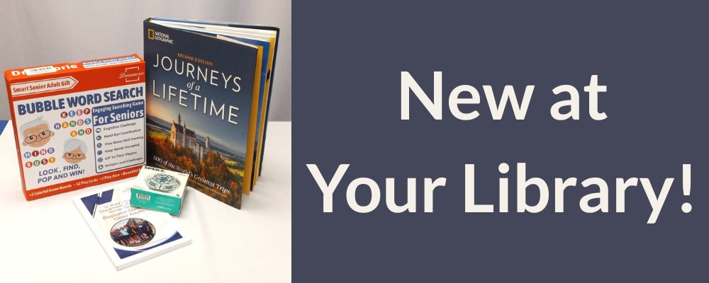 Bubble Words Search Game, Journeys of a Lifetime book, and a Magnetic Fidget Set box displayed on a table. Text reads New at Your Library!