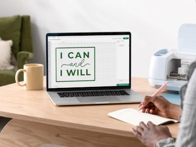 A laptop with a design program open and a file reading I can and I will. 