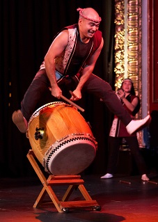  A Taiko drummer leaping over a drum
