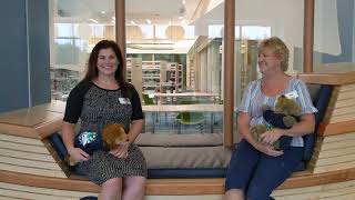 Two women holding stuffed animals