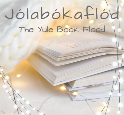 A stack of open books surrounded by twinkling lights. Jólabókaflód. The Yule Book Flood. 