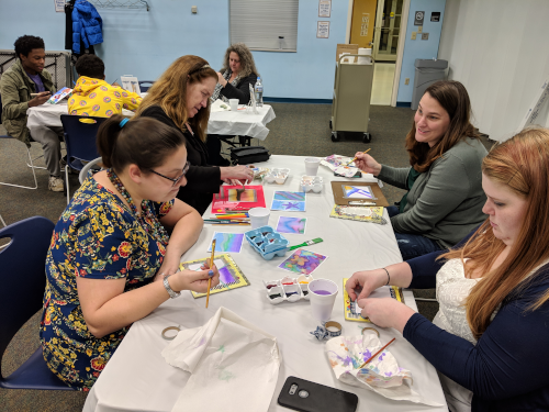 photo of 5 women and 2 men painting