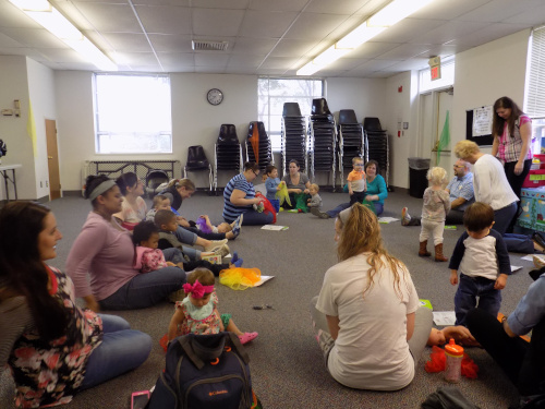photo of a group of adults and babies at a storytime